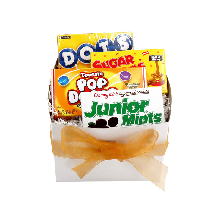 Assorted Tootsie Pop candy packages with a yellow bow on a white background