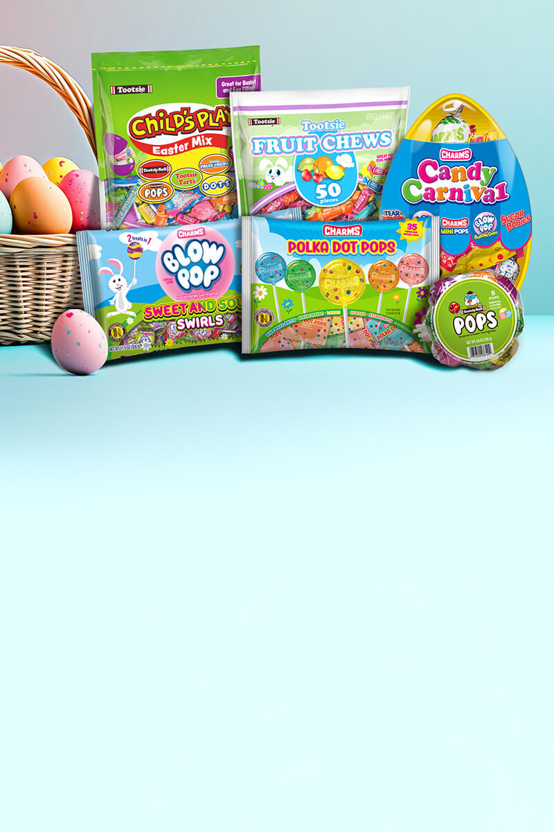 Assorted Easter candies displayed against a light blue background, featuring bags of Tootsie, Blow Pop, and Charms, with a basket of colorful eggs.