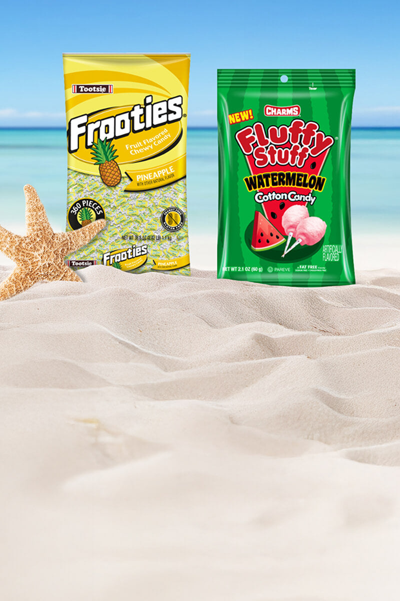 Tootsie frooties and Charms fluffy stuff watermelon on the beach with sea star next to it.