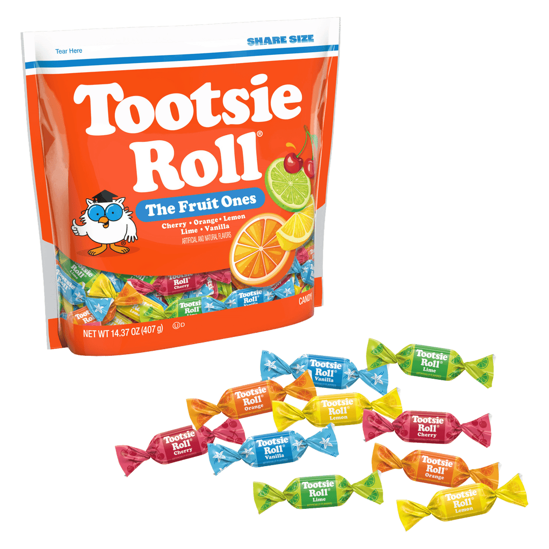 A large bag of Tootsie Roll The Fruit Ones candy is shown on a white background with several individually wrapped candies arranged in front. The bag is bright orange with white Tootsie Roll branding and fruit illustrations, and the candies are wrapped in colorful paper.