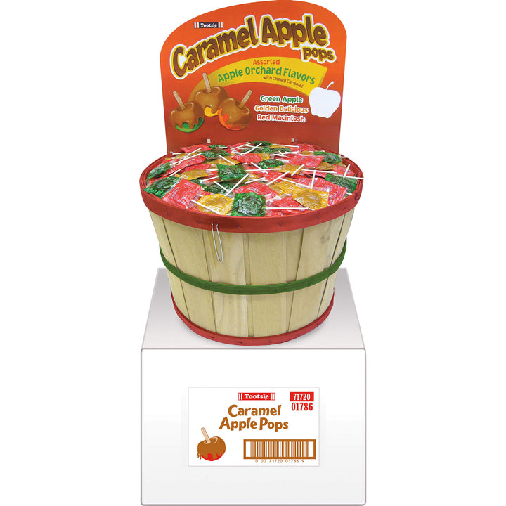 Display of Caramel Apple Pops with a wooden basket on a white background